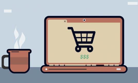 A laptop screen displays an online shopping cart.